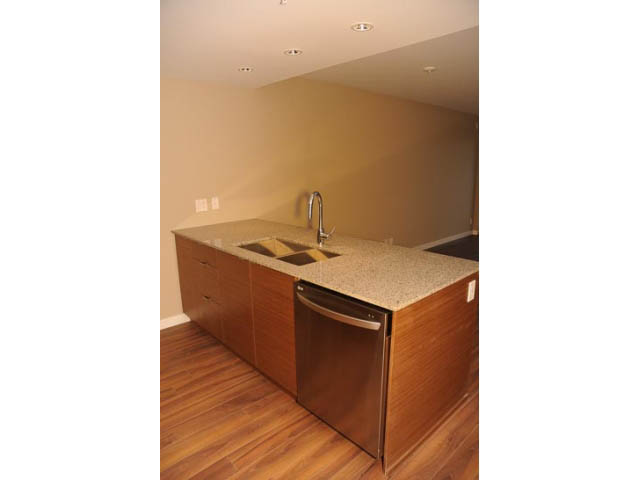 Bright kitchen with granite countertops, hardwood floors, and recessed lighting. - 310 - 135 East 17th Street, North Vancouver