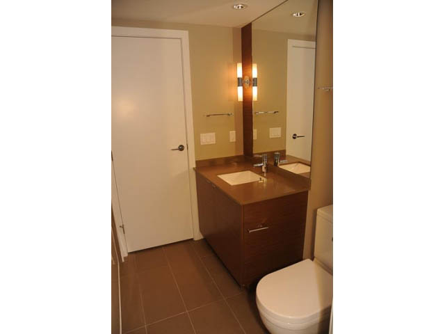Furnished bathroom with wooden vanity and modern lighting. - 310 - 135 East 17th Street, North Vancouver