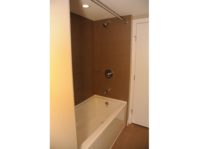Furnished bathroom with glass shower and modern fixtures. - 310 - 135 East 17th Street, North Vancouver