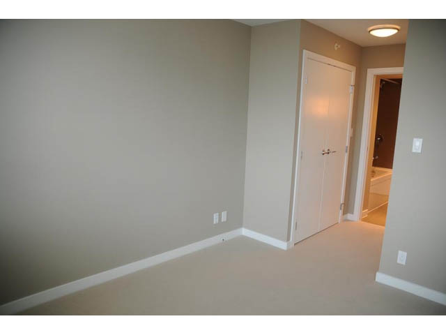 Bright den with white walls, carpeted floor, and open door leading to another room. - 310 - 135 East 17th Street, North Vancouver