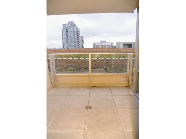 Furnished balcony with city view and modern railings. - 310 - 135 East 17th Street, North Vancouver
