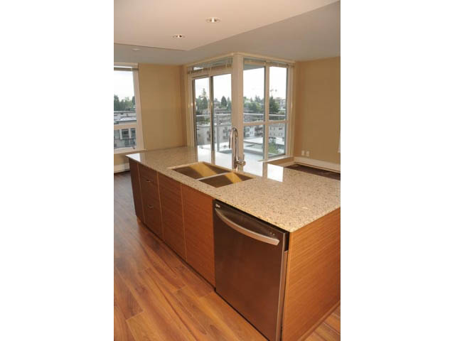 Bright kitchen with granite countertops, hardwood floors, and a city view. - 707-135 East 17th Street, North Vancouver