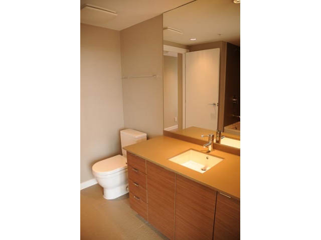 Furnished bathroom with wooden cabinets and modern sink. - 707-135 East 17th Street, North Vancouver