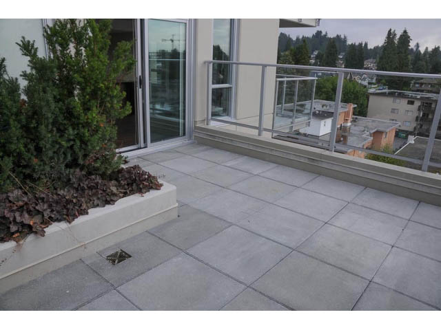 Furnished balcony with sliding glass door and city view. - 707-135 East 17th Street, North Vancouver
