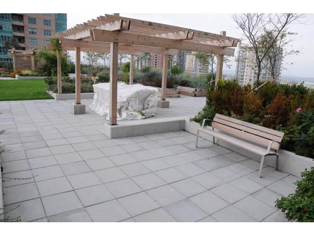 Furnished patio with wooden pergola and city view. - 707-135 East 17th Street, North Vancouver