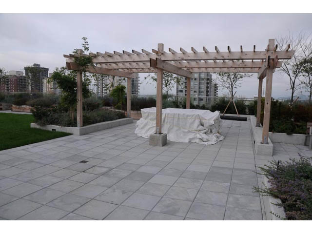 Furnished patio with wooden pergola and city view. - 707-135 East 17th Street, North Vancouver