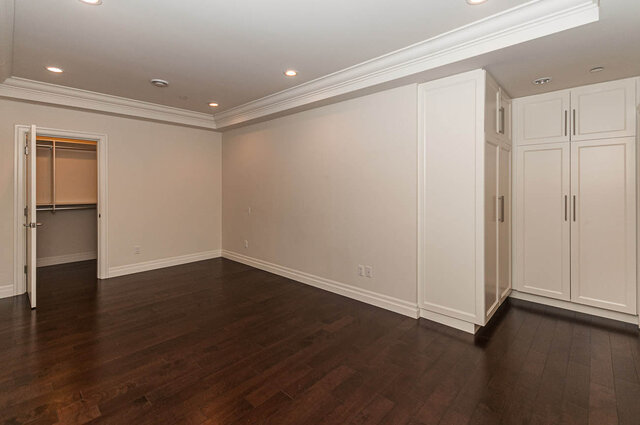 Spacious living room with hardwood floors and built-in cabinets. - 3560 Maple Street, Vancouver West Side