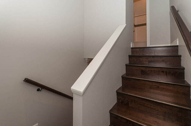 Modern staircase with dark wood treads and white railings leads to the upper level. - 3560 Maple Street, Vancouver West Side