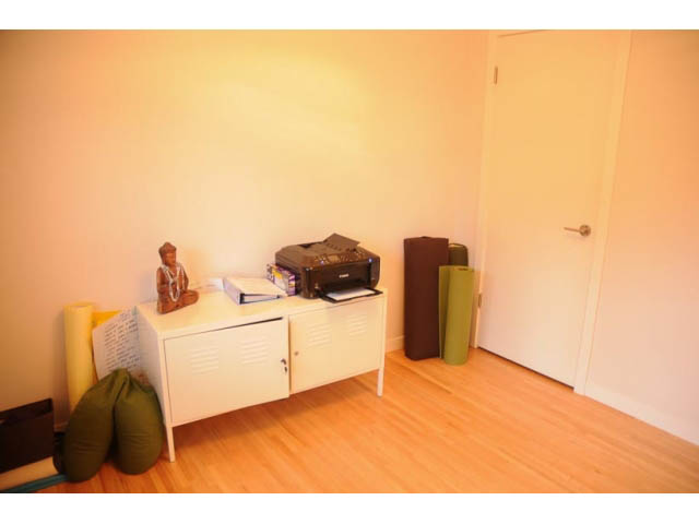 Bright den with white cabinets, hardwood floors, and a printer on the counter. - 1362 East 20th St, North Vancouver