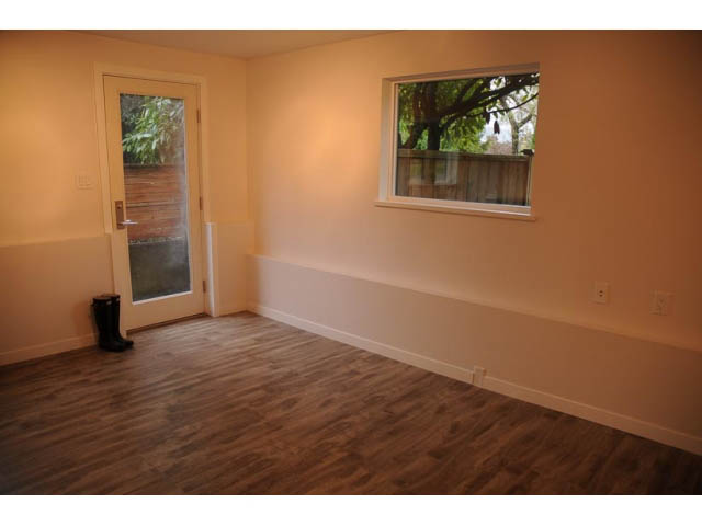 Bright den with hardwood floors and a sliding glass door leading outside. - 1362 East 20th St, North Vancouver