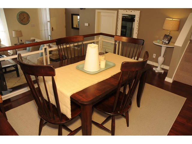 Furnished dining area with wooden chairs and table, hardwood floors, and a cozy ambiance. - 121 -1228 Marinaside Crescent, Vancouver Downtown