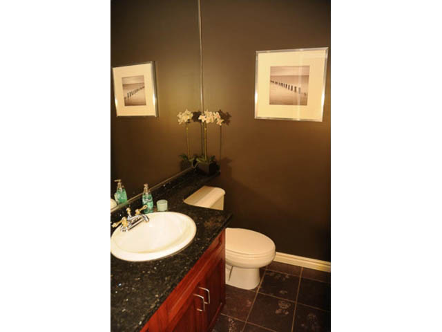 Furnished bathroom with dark countertops and framed artwork. - 121 -1228 Marinaside Crescent, Vancouver Downtown