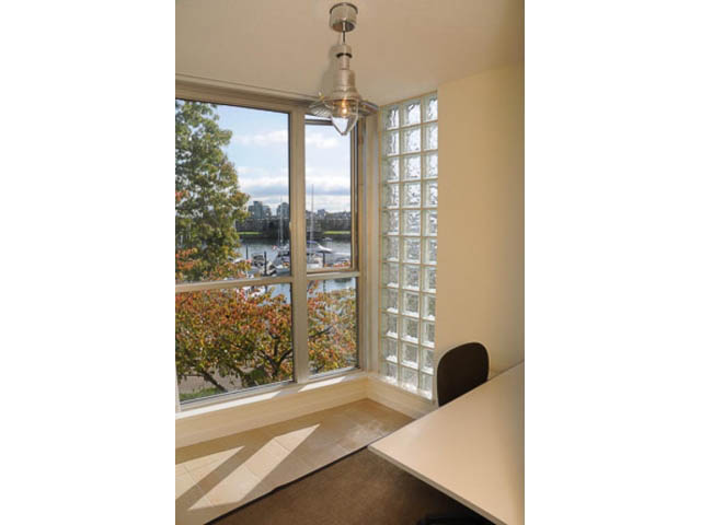 Bright sunroom with large windows, city view, and glass block wall. - 121 -1228 Marinaside Crescent, Vancouver Downtown