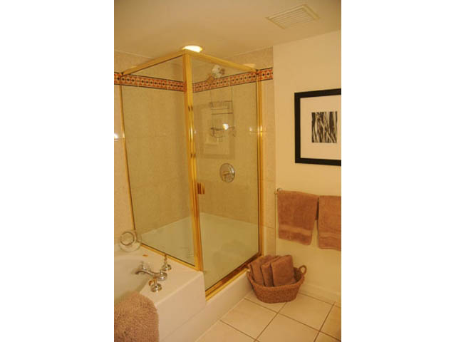 Furnished bathroom with gold-framed shower and countertop sink. - 121 -1228 Marinaside Crescent, Vancouver Downtown