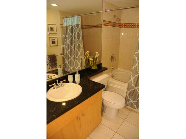 Furnished bathroom with black countertops and white toilet. - 121 -1228 Marinaside Crescent, Vancouver Downtown