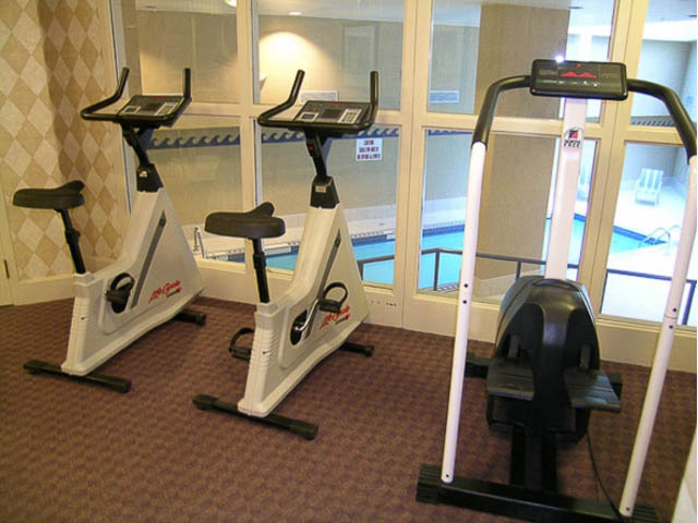 Fitness room with cardio equipment and large windows. - 121 -1228 Marinaside Crescent, Vancouver Downtown