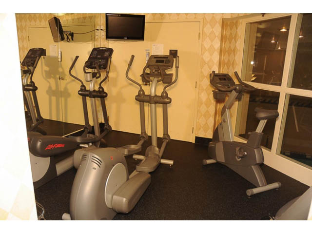 Bright gym with elliptical machines and mirrors. - 121 -1228 Marinaside Crescent, Vancouver Downtown