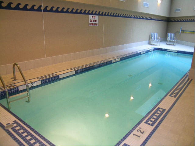 Spacious indoor pool with tiled edges and lounge chairs. - 121 -1228 Marinaside Crescent, Vancouver Downtown