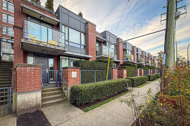 Modern townhouse with large windows, brick facade, and lush green landscaping. - 3238 Tupper Street, Vancouver West Side