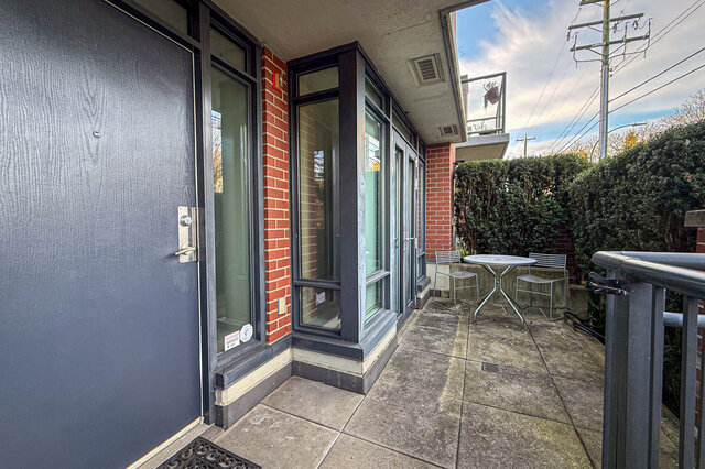 Spacious patio with modern glass doors, outdoor seating, and lush greenery. - 3238 Tupper Street, Vancouver West Side