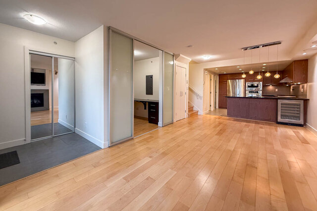 Spacious open-concept living area with hardwood floors and modern kitchen featuring a wine fridge. - 3238 Tupper Street, Vancouver West Side