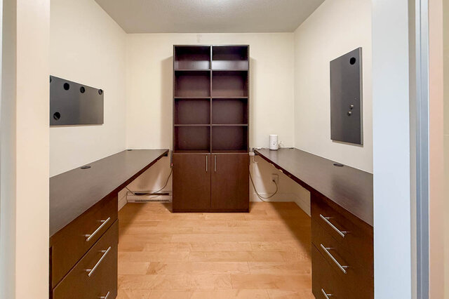 Spacious den with dark wood cabinets, built-in shelving, and hardwood floors. - 3238 Tupper Street, Vancouver West Side