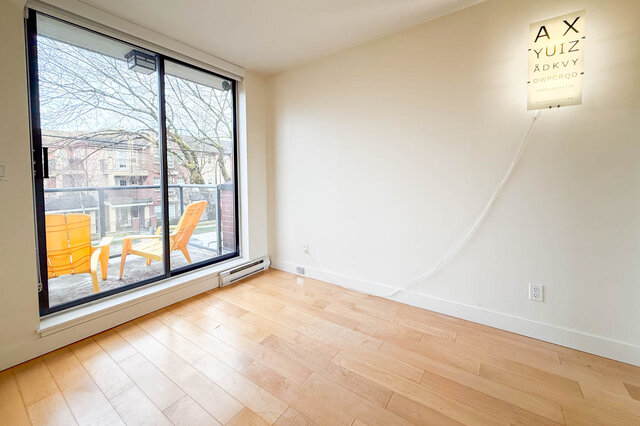 Spacious living room with hardwood floors, large sliding door, and city view. - 3238 Tupper Street, Vancouver West Side