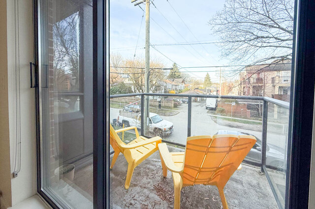 Furnished balcony with yellow Adirondack chairs and a view of a quiet street and houses. - 3238 Tupper Street, Vancouver West Side