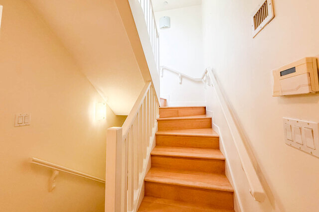 Bright, cozy staircase leading to the upper level with wooden steps and white railings. - 3238 Tupper Street, Vancouver West Side