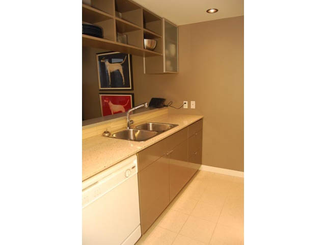 Bright kitchen with light countertops and modern cabinetry, featuring a sink and dishwasher. - 911 - 939 Expo Boulevard, Vancouver Downtown