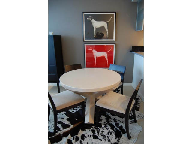 Furnished dining area with cowhide rug, modern artwork, and white countertops. - 911 - 939 Expo Boulevard, Vancouver Downtown
