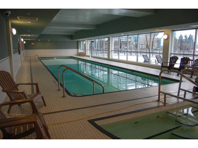 Spacious indoor pool with lounge chairs and city view. - 911 - 939 Expo Boulevard, Vancouver Downtown
