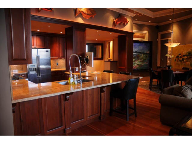 Bright kitchen with wooden cabinets, granite countertops, and hardwood floors. - 654 Millbank, Vancouver West Side