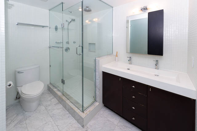 Modern bathroom with marble countertops and dark wood cabinets. - 834 W 7th Ave, Vancouver West Side
