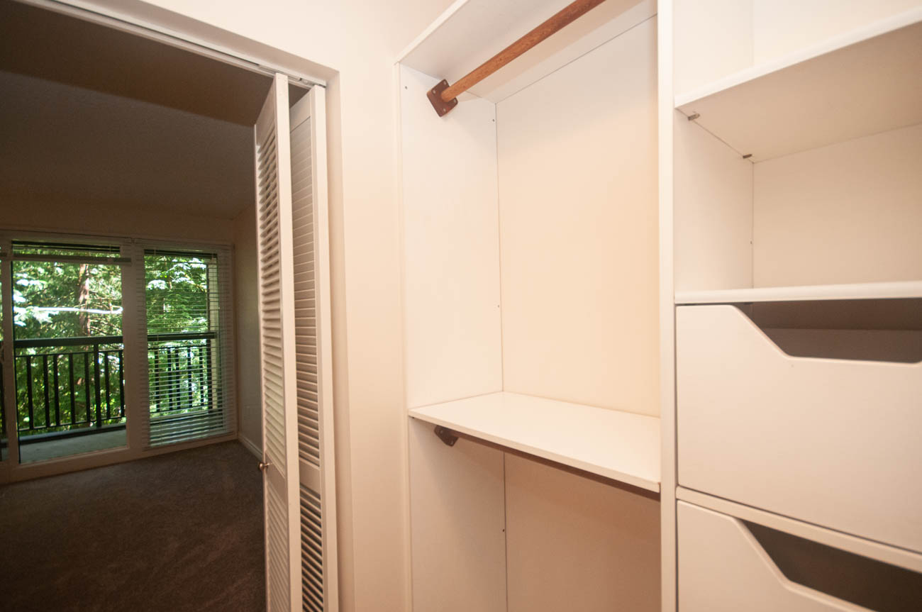 Spacious walk-in closet with built-in shelves and a view of greenery outside. - 1059 Heritage Blvd, North Vancouver