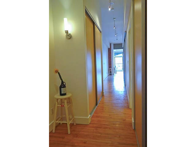 Bright hallway with hardwood floors and a wall-mounted light fixture. - 207 - 345 Water St, Vancouver Downtown
