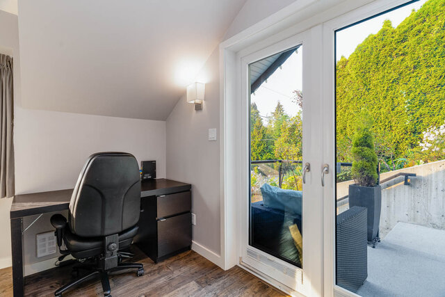 Spacious home office with hardwood floors, a comfortable desk, and a view of lush greenery outside. - 420-B Tempe Crescent, North Vancouver