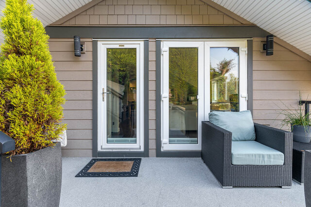 Furnished patio with wicker furniture and a view of lush greenery. - 420-B Tempe Crescent, North Vancouver