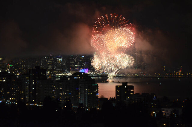 Furnished 2-bedroom house with a stunning city view and vibrant fireworks display at night. - 420-B Tempe Crescent, North Vancouver