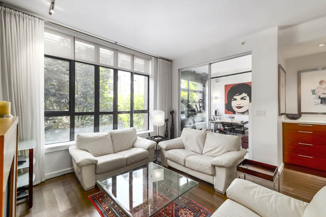 Spacious living room with large windows, modern furniture, and a city view. - 302 - 1241 Homer Street, Vancouver Downtown