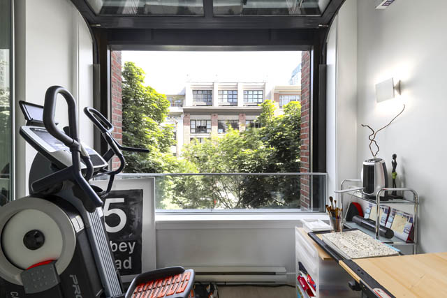 Bright living room with city view and modern decor, featuring a sleek sofa and large windows. - 302 - 1241 Homer Street, Vancouver Downtown