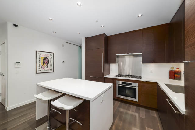 Bright kitchen with white countertops and dark wood cabinets, modern design. - 302 - 1241 Homer Street, Vancouver Downtown