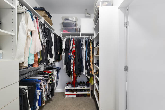 Spacious walk-in closet with neatly organized clothes and shoe storage. - 302 - 1241 Homer Street, Vancouver Downtown