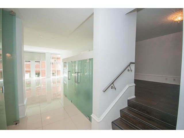 Bright living room with glass walls and modern staircase leading to upper level. - 403 - 1102 Hornby St
403 - 1102 Hornby Street, Vancouver Downtown