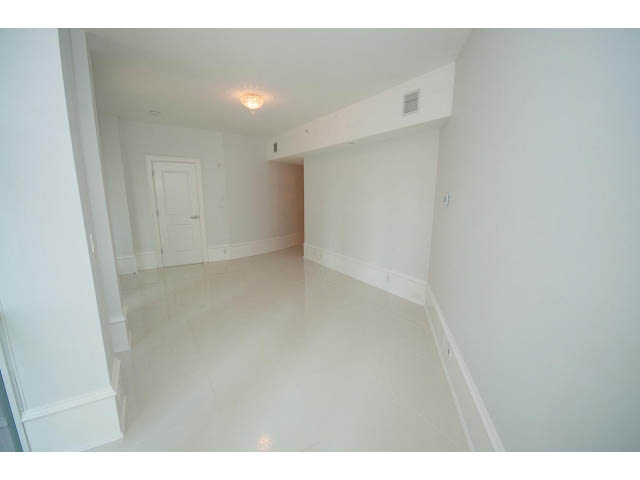 Bright and airy den with white walls and ceiling, leading to a hallway. - 403 - 1102 Hornby St
403 - 1102 Hornby Street, Vancouver Downtown