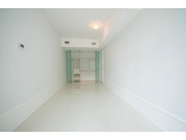 Bright hallway with glossy white floors and glass doors leading to another room. - 403 - 1102 Hornby St
403 - 1102 Hornby Street, Vancouver Downtown