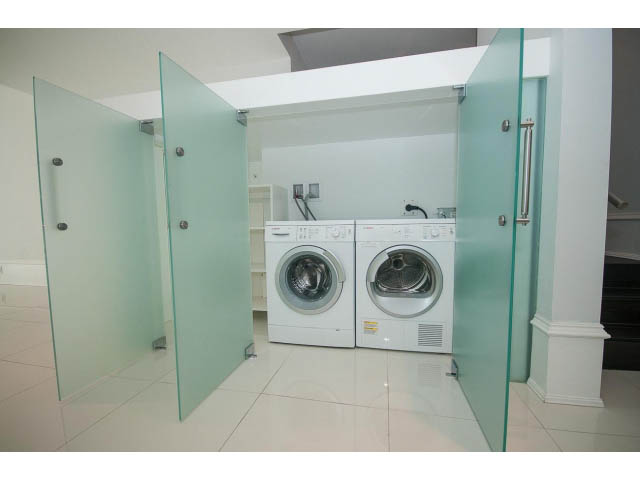 Bright laundry room with glass doors, modern appliances, and tiled floor. - 403 - 1102 Hornby St
403 - 1102 Hornby Street, Vancouver Downtown