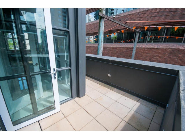 Furnished balcony with sliding glass doors, tiled flooring, and city view. - 403 - 1102 Hornby St
403 - 1102 Hornby Street, Vancouver Downtown