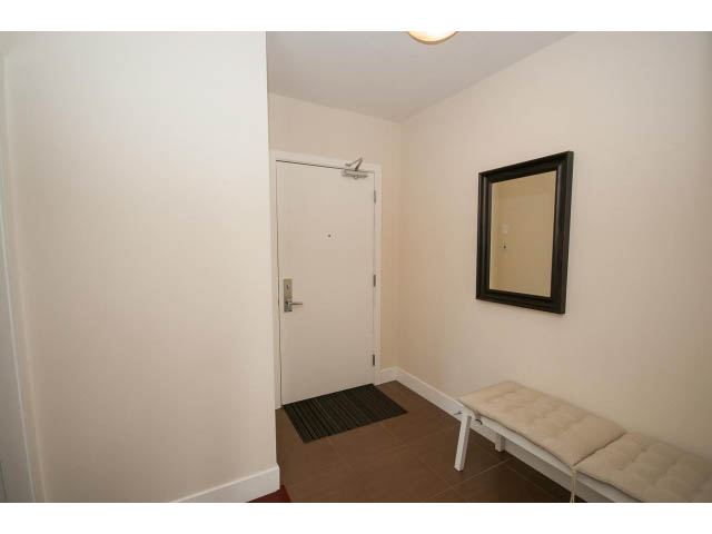 Foyer with bench, mirrors, and door leading to another room. - 1606-158 West 13th Street, North Vancouver
