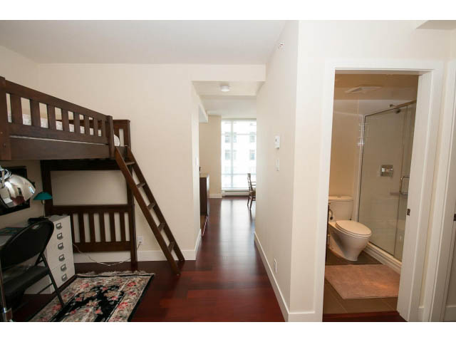 Bright living room with hardwood floors and a cozy bunk bed setup. - 1606-158 West 13th Street, North Vancouver